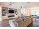 Bright living room featuring custom built-ins, a modern fireplace, and an adjacent dining area at 3027 Key Harbor Dr, Safety Harbor, FL 34695