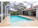 A beautiful screened-in pool with tile deck and outdoor kitchen is perfect for entertaining and enjoying the outdoors at 3027 Key Harbor Dr, Safety Harbor, FL 34695