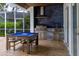Well-appointed outdoor entertaining space with a screened-in pool and grill at 3027 Key Harbor Dr, Safety Harbor, FL 34695