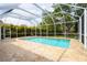 Inviting screened-in pool area with stone decking, lush landscaping and an open-air feel at 3027 Key Harbor Dr, Safety Harbor, FL 34695
