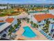 Aerial view of the community pool with a baseball field and tennis courts in the background at 315 Medallion Blvd # E, Madeira Beach, FL 33708