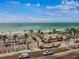 An aerial view showcasing the beach, a restaurant, and parking area at 315 Medallion Blvd # E, Madeira Beach, FL 33708