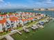 Aerial view showcasing a waterfront complex with private boat docks and stunning water views at 315 Medallion Blvd # E, Madeira Beach, FL 33708