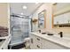 Bathroom features a glass-enclosed shower, dual sink vanity, and modern fixtures and hardware at 315 Medallion Blvd # E, Madeira Beach, FL 33708