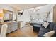Inviting bedroom with wood floors, dresser, and comfortable blue sofa at 315 Medallion Blvd # E, Madeira Beach, FL 33708