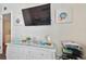 Bedroom with a dresser with coastal decorations, plus a wall-mounted TV at 315 Medallion Blvd # E, Madeira Beach, FL 33708