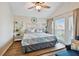 Bedroom featuring a queen bed, ceiling fan and coastal themed decor at 315 Medallion Blvd # E, Madeira Beach, FL 33708