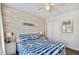 Cozy bedroom featuring coastal decor, a comfortable bed, and a bright window at 315 Medallion Blvd # E, Madeira Beach, FL 33708