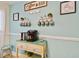Charming coffee bar setup with a Keurig machine, decorative mugs, and coffee-themed artwork on a light blue wall at 315 Medallion Blvd # E, Madeira Beach, FL 33708