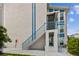 Side exterior with blue staircase leading to the condo door at 315 Medallion Blvd # E, Madeira Beach, FL 33708