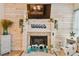 Close-up of a cozy fireplace with beach-themed decorations at 315 Medallion Blvd # E, Madeira Beach, FL 33708