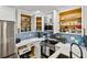 Bright kitchen featuring white cabinets, stainless steel appliances, and stylish backsplash tile at 315 Medallion Blvd # E, Madeira Beach, FL 33708