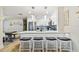 Bright kitchen boasts stainless appliances, white cabinets, counter seating, and modern pendant lighting at 315 Medallion Blvd # E, Madeira Beach, FL 33708