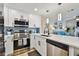 The updated kitchen features stainless appliances, white cabinets, and modern fixtures at 315 Medallion Blvd # E, Madeira Beach, FL 33708