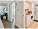 Bright laundry room featuring a washer and dryer, plus hallway view into a tastefully decorated living room at 315 Medallion Blvd # E, Madeira Beach, FL 33708