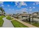 Picturesque marina with boats docked along a modern walkway, palm trees, and manicured green spaces at 315 Medallion Blvd # E, Madeira Beach, FL 33708