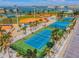 Aerial view of well maintained tennis and sports courts in a waterfront community at 315 Medallion Blvd # E, Madeira Beach, FL 33708