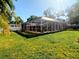 A spacious screened-in outdoor patio with lush green grass surrounds this outdoor space at 3217 W Lawn Ave, Tampa, FL 33611