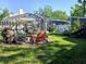 Grassy backyard features an outdoor fire pit, comfortable seating, and a screened-in pool area for relaxation and entertainment at 3217 W Lawn Ave, Tampa, FL 33611