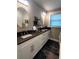 A bathroom featuring double sinks, modern lighting, and ample counter space at 3217 W Lawn Ave, Tampa, FL 33611