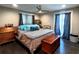 A comfortable and well-lit bedroom featuring a bed, ceiling fan, and neutral tones at 3217 W Lawn Ave, Tampa, FL 33611