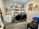 Well-organized laundry room with modern washer and dryer, shelving and decor at 3217 W Lawn Ave, Tampa, FL 33611