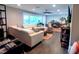 Bright, spacious living room with hardwood floors, modern furniture, and large window at 3217 W Lawn Ave, Tampa, FL 33611