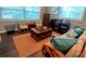 Cozy living room with lots of seating and a beautiful coffee table next to lots of natural light from the window at 3217 W Lawn Ave, Tampa, FL 33611