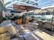 The patio features a grill, dining table, seating, lush landscaping, and pool in a screened enclosure at 3217 W Lawn Ave, Tampa, FL 33611