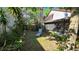Spacious backyard featuring mature trees and foliage, complemented by a comfortable lounge chair at 3527 Greenglen Cir, Palm Harbor, FL 34684