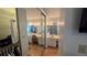 Bathroom featuring dual sinks and a walk in closet with mirrored doors at 3527 Greenglen Cir, Palm Harbor, FL 34684