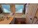 Bathroom featuring a soaking tub and glass block window at 3527 Greenglen Cir, Palm Harbor, FL 34684