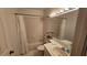 Bright bathroom featuring a combination bathtub and shower, a vanity with sink, and neutral tile at 3527 Greenglen Cir, Palm Harbor, FL 34684