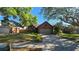 Charming single Gathering brick home featuring a manicured front yard and attached garage in a quiet neighborhood at 3527 Greenglen Cir, Palm Harbor, FL 34684