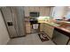 A bright kitchen featuring stainless steel appliances and a tile floor at 3527 Greenglen Cir, Palm Harbor, FL 34684