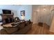 Cozy living room with a classic brick fireplace, comfortable seating, and warm wood laminate flooring at 3527 Greenglen Cir, Palm Harbor, FL 34684