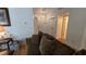 Comfortable living room showcasing a plush sofa, wood laminate flooring, and entry to bedroom and baths at 3527 Greenglen Cir, Palm Harbor, FL 34684
