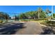 Community tennis courts with secure gated entry and attractive landscaping at 3527 Greenglen Cir, Palm Harbor, FL 34684
