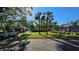 Landscaped tennis courts at this community include nearby covered benches and clubhouse at 3527 Greenglen Cir, Palm Harbor, FL 34684