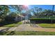 Community tennis courts with secure entry and nearby shaded benches at 3527 Greenglen Cir, Palm Harbor, FL 34684