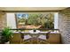 Balcony with table and chairs offers views of lush greenery and golf course at 36750 Us 19 N # 20211, Palm Harbor, FL 34684