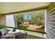 Inviting balcony features seating, offering serene views of the lush green golf course and nature at 36750 Us 19 N # 20211, Palm Harbor, FL 34684