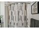 Clean bathroom featuring geometric pattern shower curtain, decorative print, and neutral color scheme at 36750 Us 19 N # 20211, Palm Harbor, FL 34684