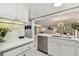 Well-lit kitchen with white countertops, stainless steel dishwasher, and stylish backsplash at 36750 Us 19 N # 20211, Palm Harbor, FL 34684
