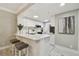 Bright kitchen featuring white cabinetry, stainless steel appliances, and a breakfast bar with seating at 36750 Us 19 N # 20211, Palm Harbor, FL 34684