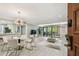Open-concept living space featuring modern decor, light floors, and a sliding glass door to a balcony at 36750 Us 19 N # 20211, Palm Harbor, FL 34684