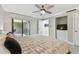 Comfortable bedroom with sliding door access to an outdoor patio and a built-in media center at 36750 Us 19 N # 20211, Palm Harbor, FL 34684