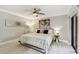 Cozy bedroom features a ceiling fan, decorative wall art, neutral color palette, and a comfortable bed at 36750 Us 19 N # 20211, Palm Harbor, FL 34684