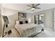 Well-lit bedroom with a ceiling fan, balcony access, stylish decor, and a spacious layout at 36750 Us 19 N # 20211, Palm Harbor, FL 34684