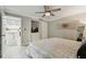 Inviting bedroom with neutral decor, ceiling fan, access to the kitchen, and plenty of natural light at 36750 Us 19 N # 20211, Palm Harbor, FL 34684